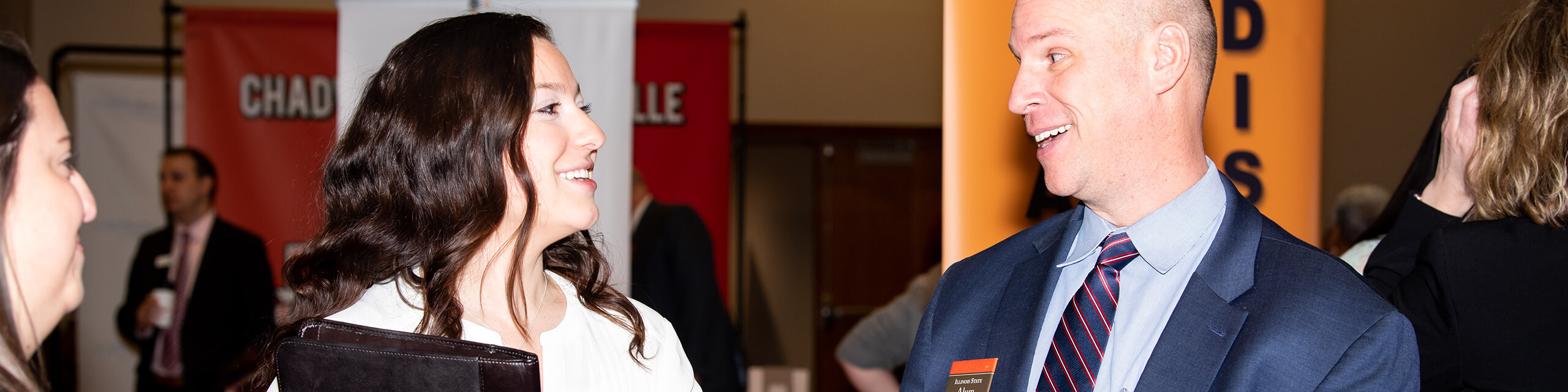 Faculty talking on a career fair event.