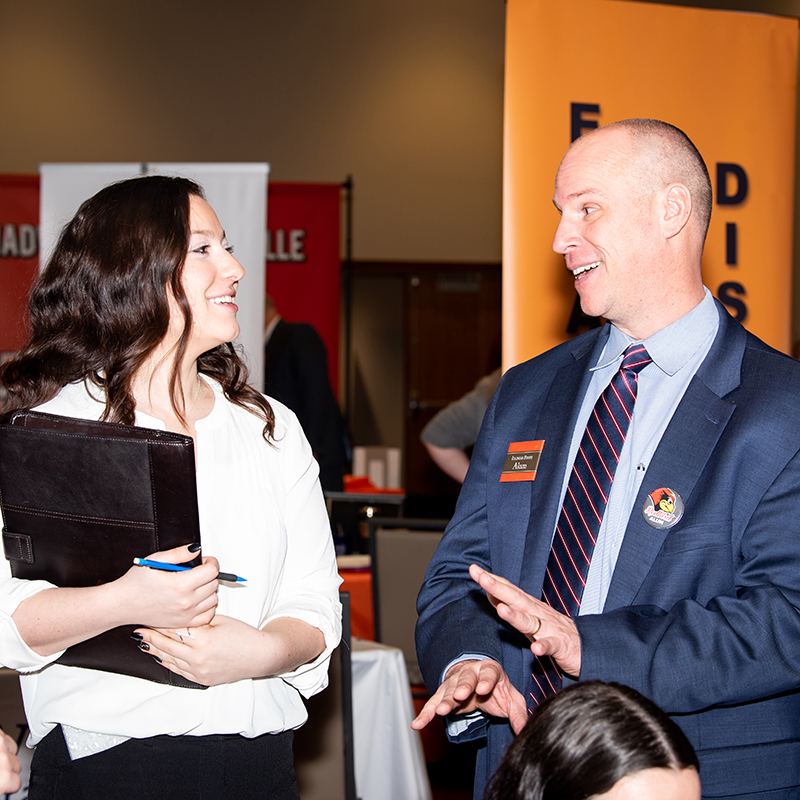 Faculty talking on a career fair event.